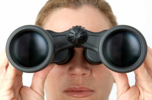 Woman looking with binoculars